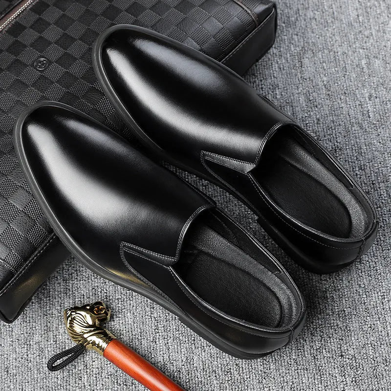 Men's black leather slip-on loafers with a rubber sole and leather toe cap on a white background.