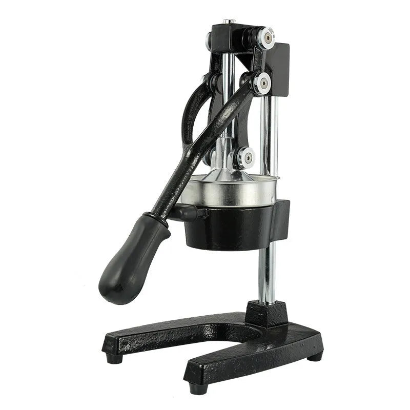 Black manual cast iron citrus juicer with stainless steel funnel on a kitchen counter.