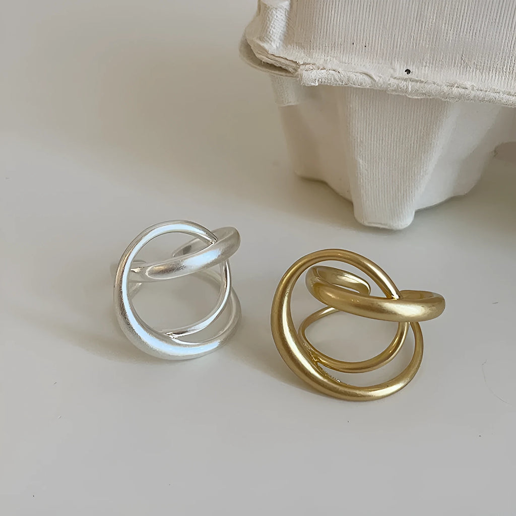 Women's geometric open ring with interlaced design in matte gold or silver tone metal
