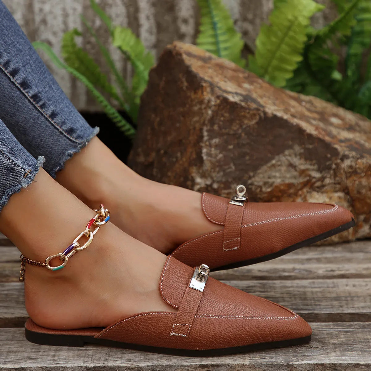 Light brown women's pointed toe slippers with a low heel, showing PU upper and rubber sole.