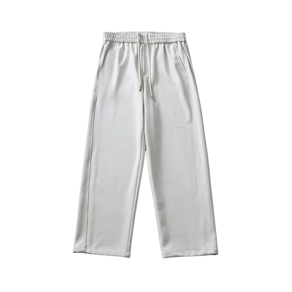 A pair of men's loose-fitting grey casual trousers with a high waist and straight leg on a plain background.