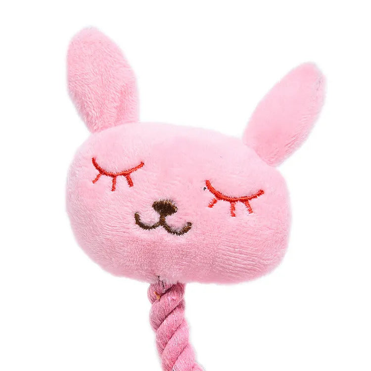 Pink rabbit-shaped plush squeaky dog toy with bite-resistant fabric placed on a light background
