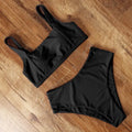 Women's high waist leopard print bikini set with push-up top and matching briefs on a mannequin.