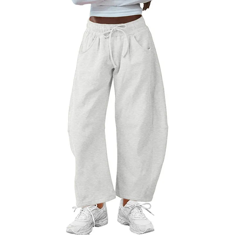 Loose cropped sweatpants with drawstring waist and side pockets in street fashion styling