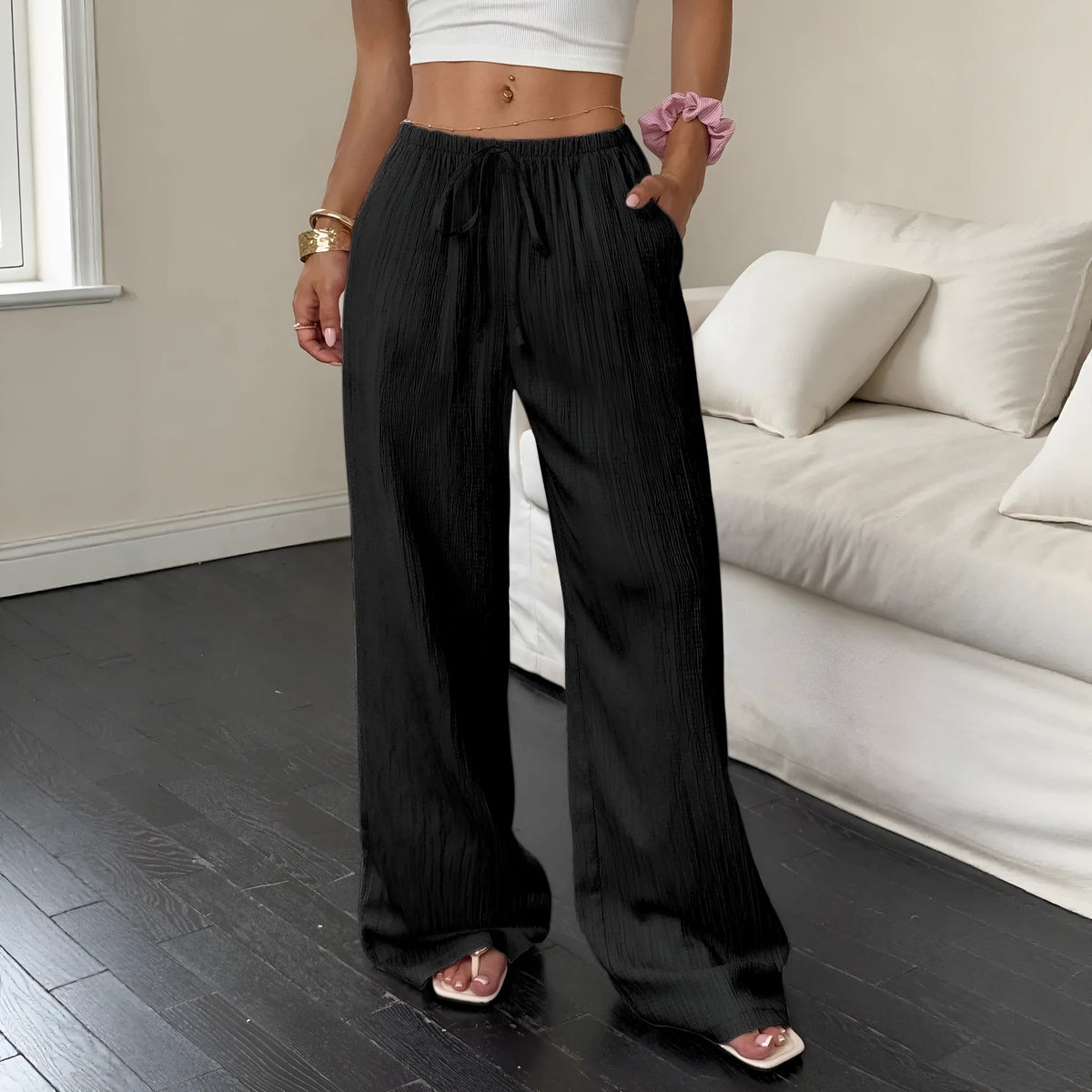 Women's mid rise wide leg lace-up waist trousers in black, polyester fabric, side view