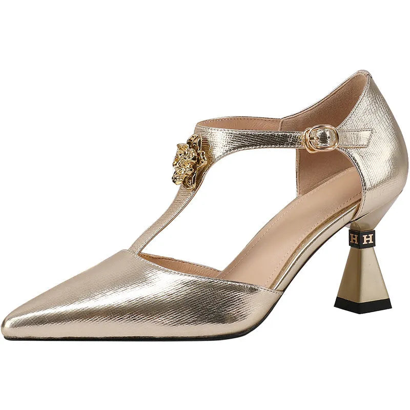 Women's gold leather sandals with hollowed design and pointed toe on a white background