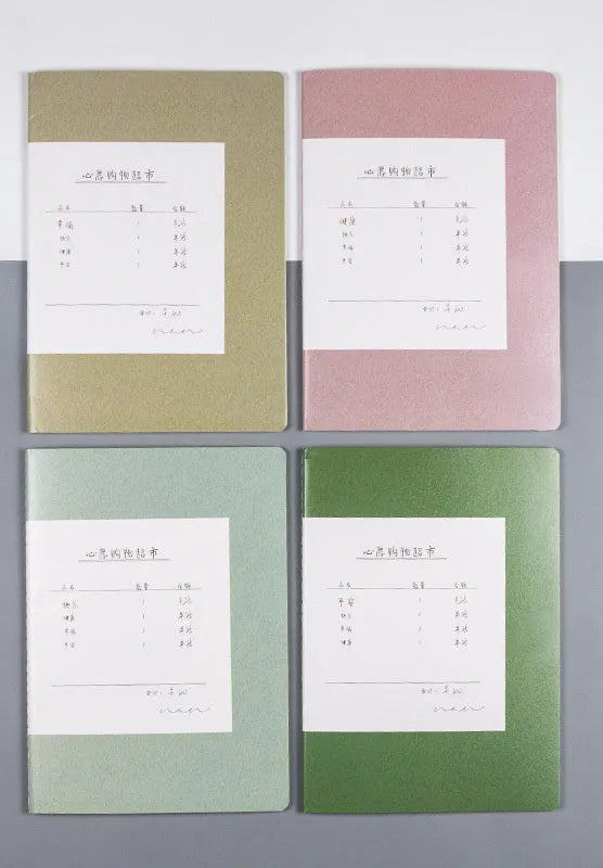 Softcover thread-bound notebook open on a table, showing flat-lay binding and lined paper.