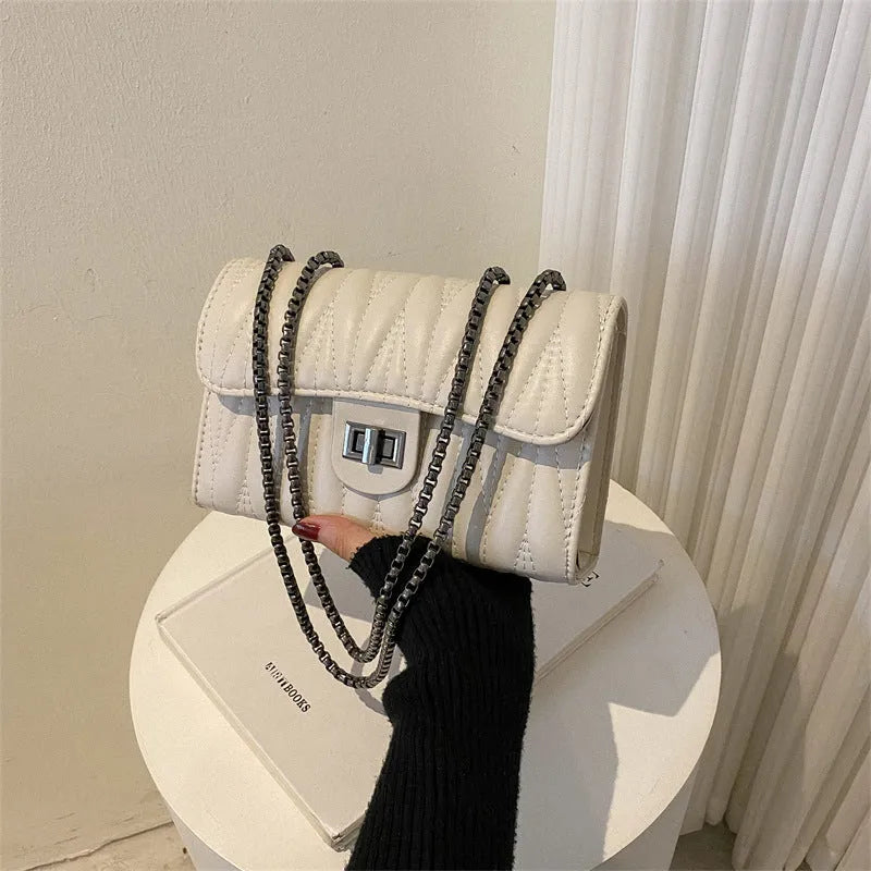 Retro textured diamond pattern women's small handbag in a choice of colours showing front view and internal phone pocket.