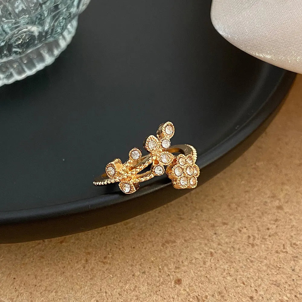 Gold diamond treated copper open ring with flower and leaf design for women