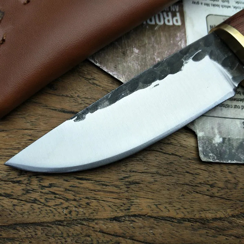 Outdoor survival knife with brown mahogany handle and 8cm stainless steel blade on wooden surface