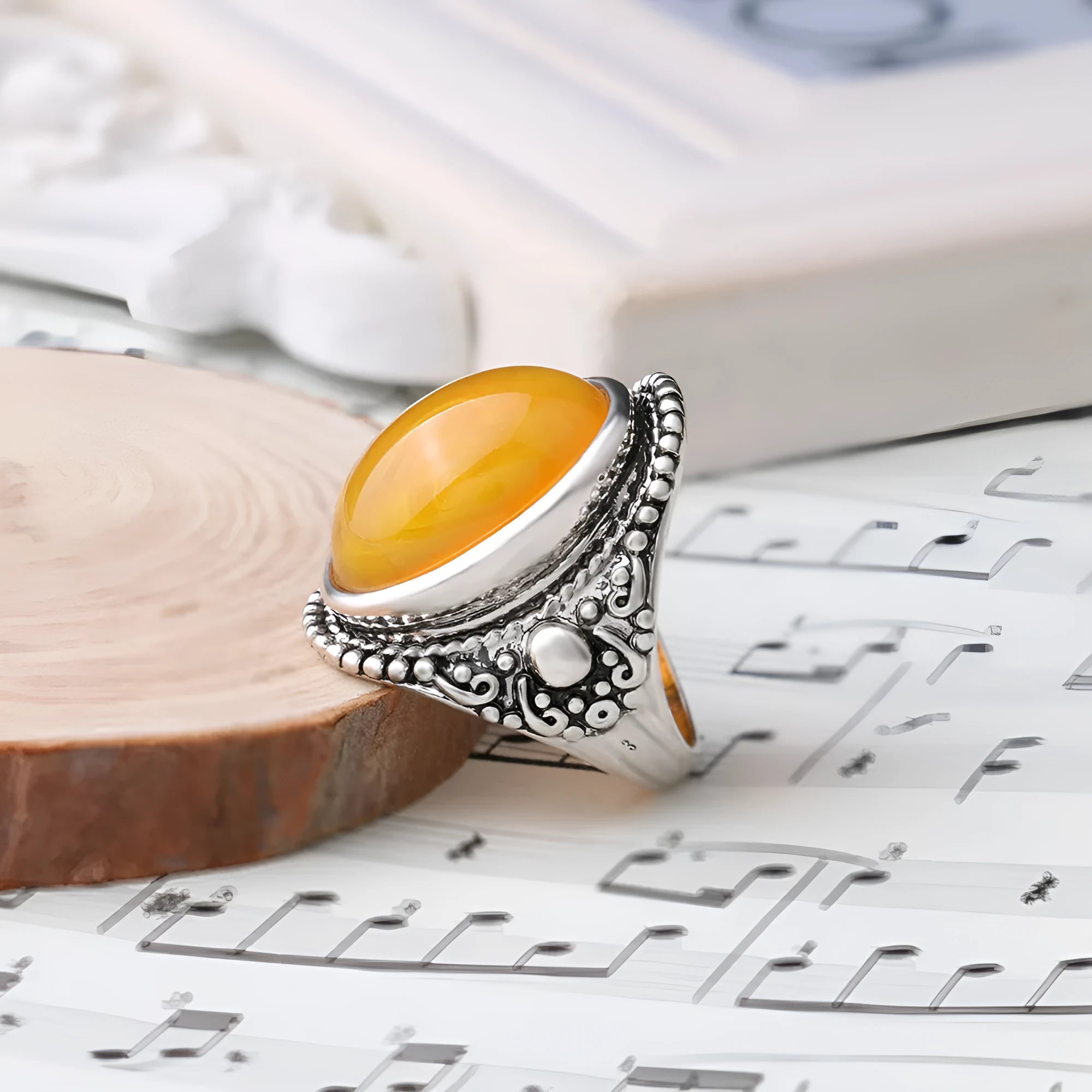 Geometric retro alloy ring in antique silver amber colour on a grey background.