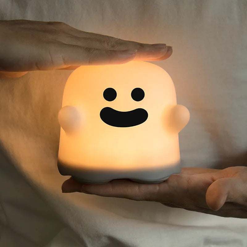 White silicone bedside night light with touch sensor base on wooden table