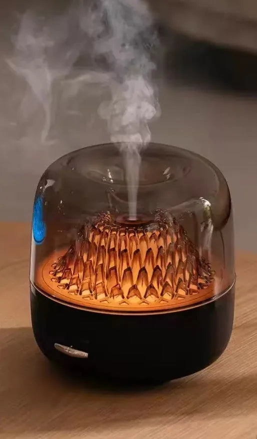 Round beige resin aroma diffuser with one fog outlet and colourful light on a desktop