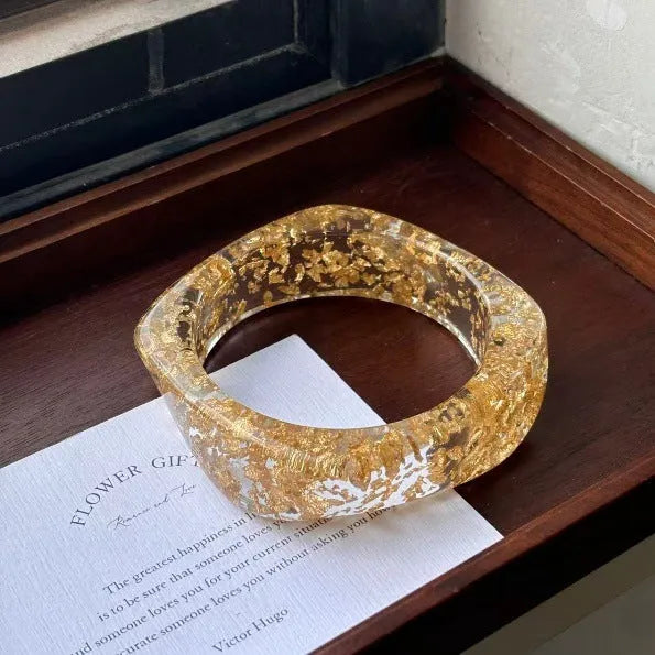 Geometric blooming resin curved bracelet in diamond transparent purple with polished finish