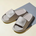 Soft non-slip EVA bathroom slippers in white, unisex flip-flop style with thick sole
