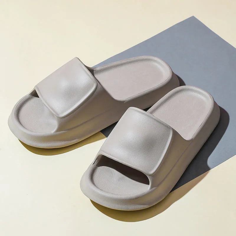 Pair of thick-soled EVA flip-flop slippers in a choice of seven colours, shown on a wet bathroom floor.