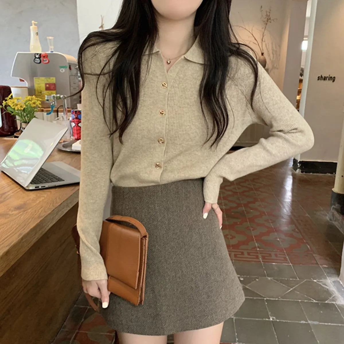 Loose fit long sleeve viscose knitted cardigan in beige, shown worn open.