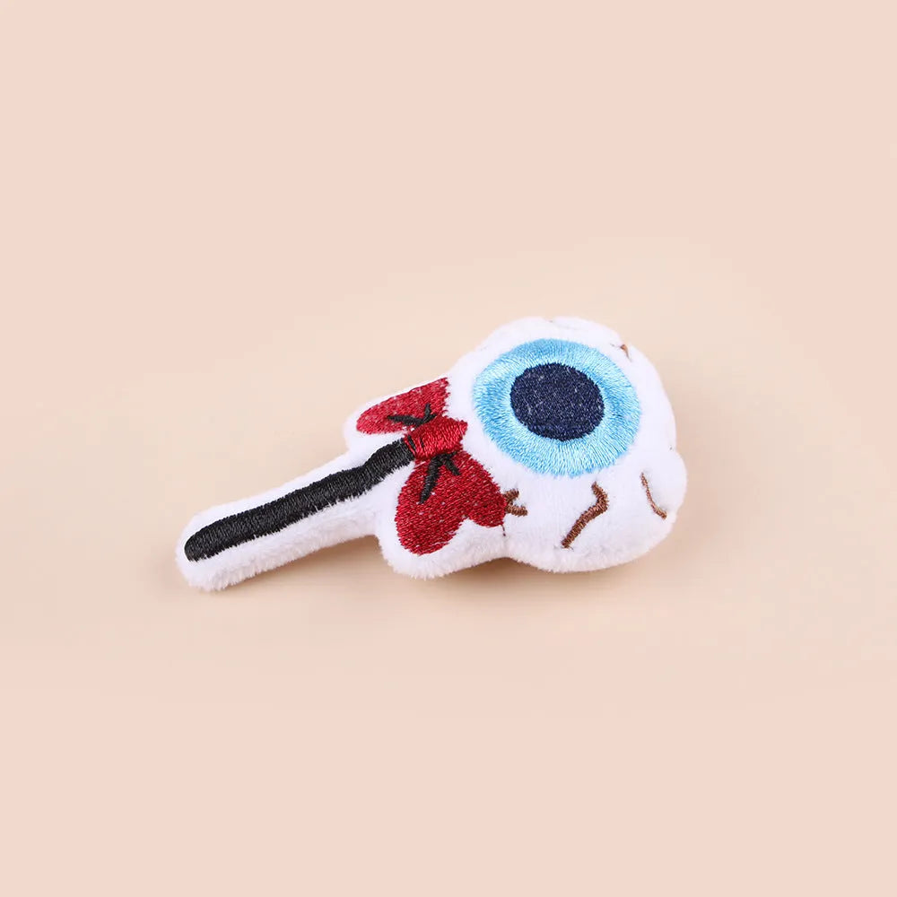 Small handheld cat teaser with plush candy and eyes attachments on wand