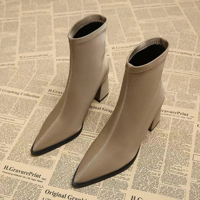 Women's khaki stretch suede pointed-toe ankle boots with a wedge heel on a white background.