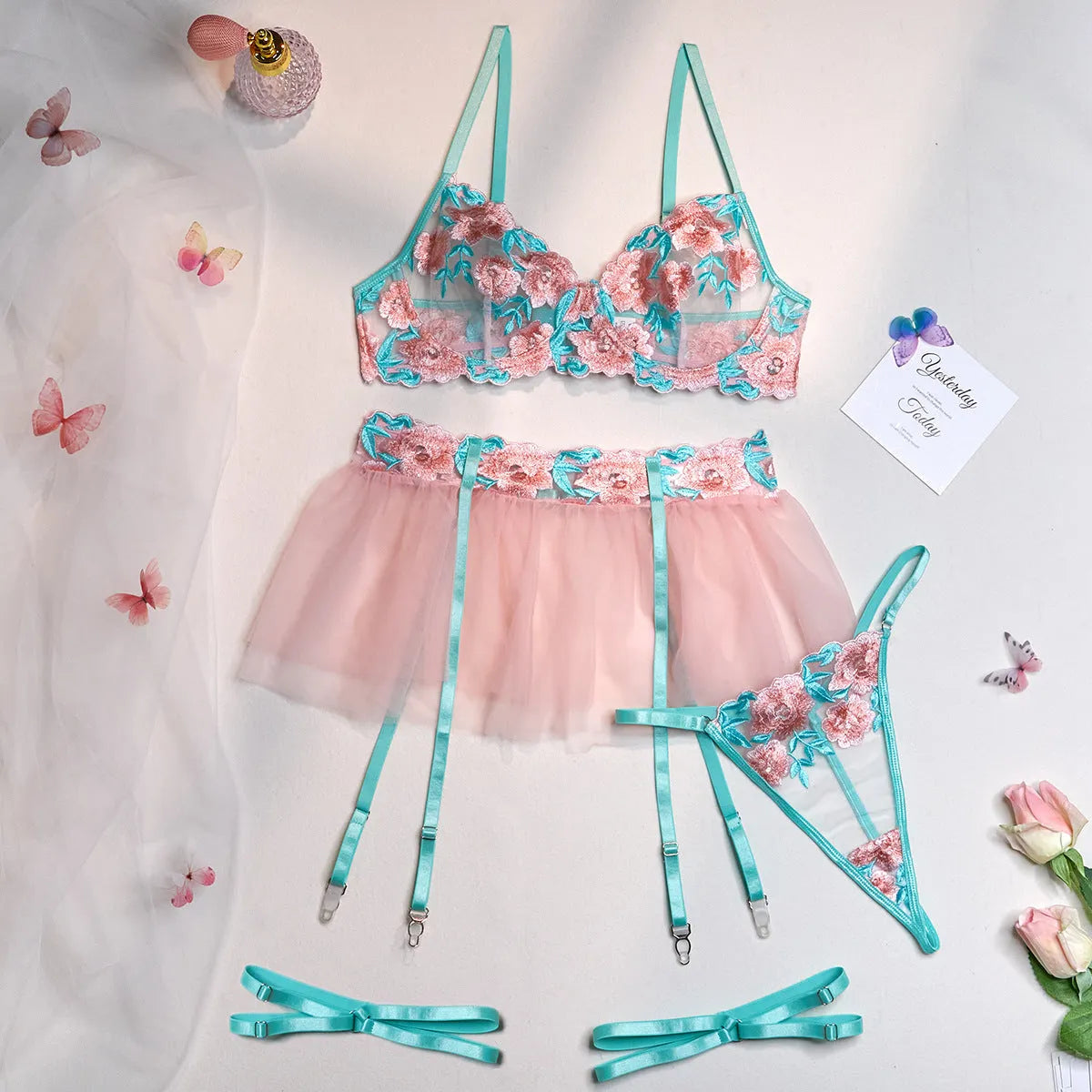 Pink women's mesh pettiskirt suit with matching embroidered bikini set on polyester fabric