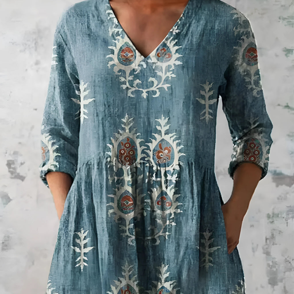 Women's floral wave print dress with wide waist and three-quarter length sleeves on a hanger.