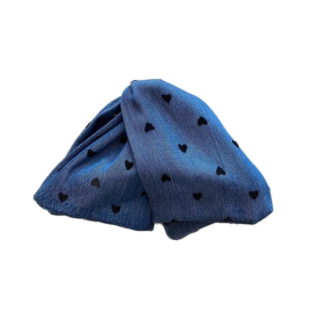 Handmade denim fabric and acrylic hair bow with triangle grip detail on plastic hairpin.