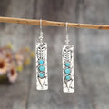 Silver geometric earrings with turquoise inlay in long strip design