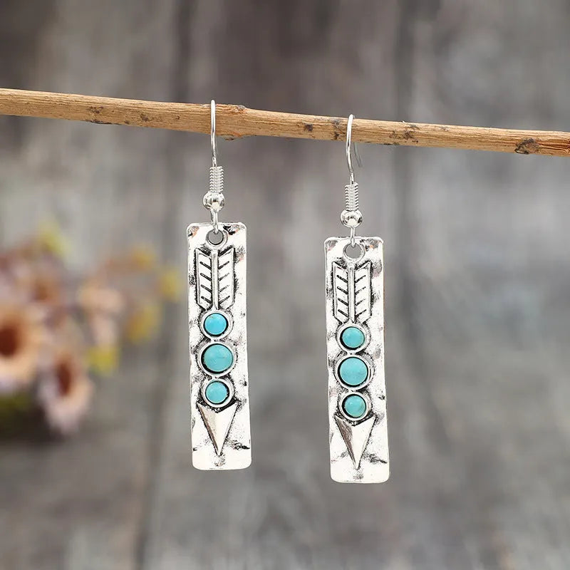 Silver geometric earrings with turquoise inlay in long strip design