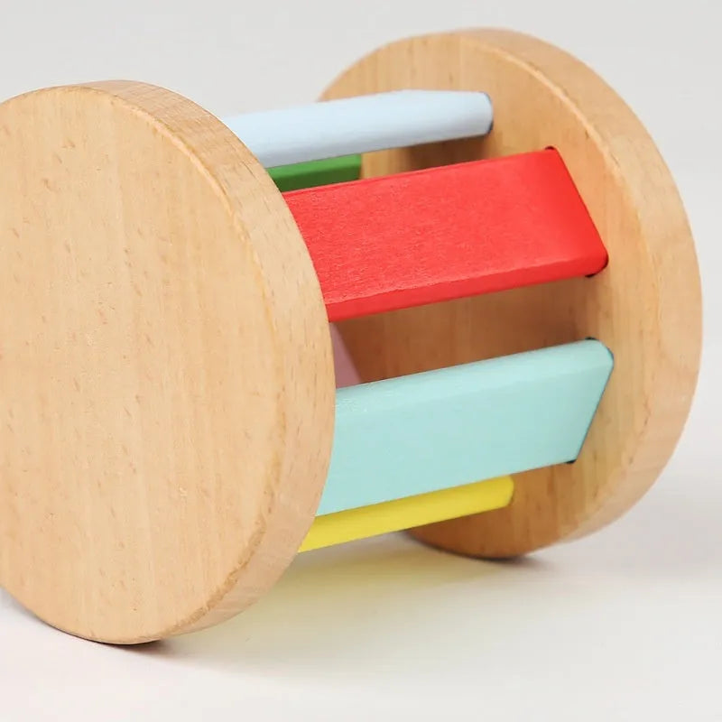Wooden infant rainbow rattle with rainbow rolling bell, 7.5x7 cm size, on a white background