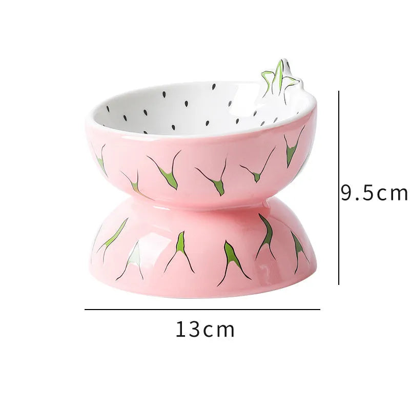 Ceramic elevated cat bowl with tilted orange fruit pattern and non-slip base.