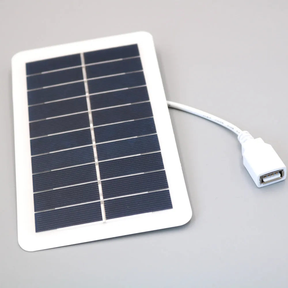 Black portable solar panel charger with USB output for mobile phones
