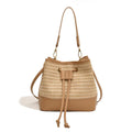 Brown woven straw women's crossbody bucket bag with a long adjustable strap.