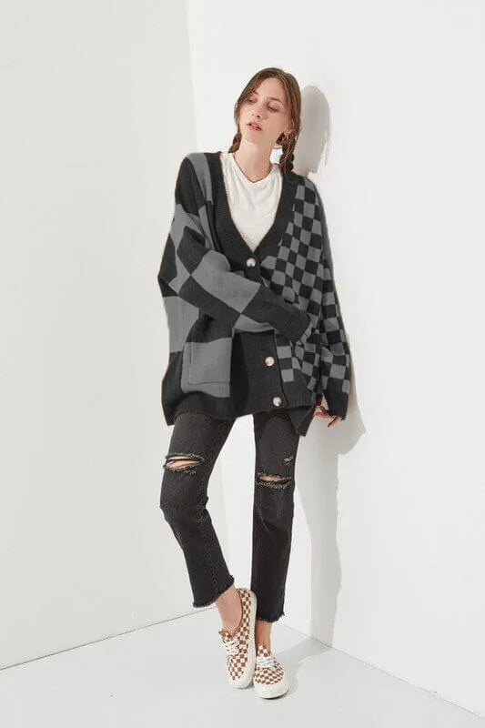 Loose fit knitwear cardigan with checks print in a selection of colours on a hanger.