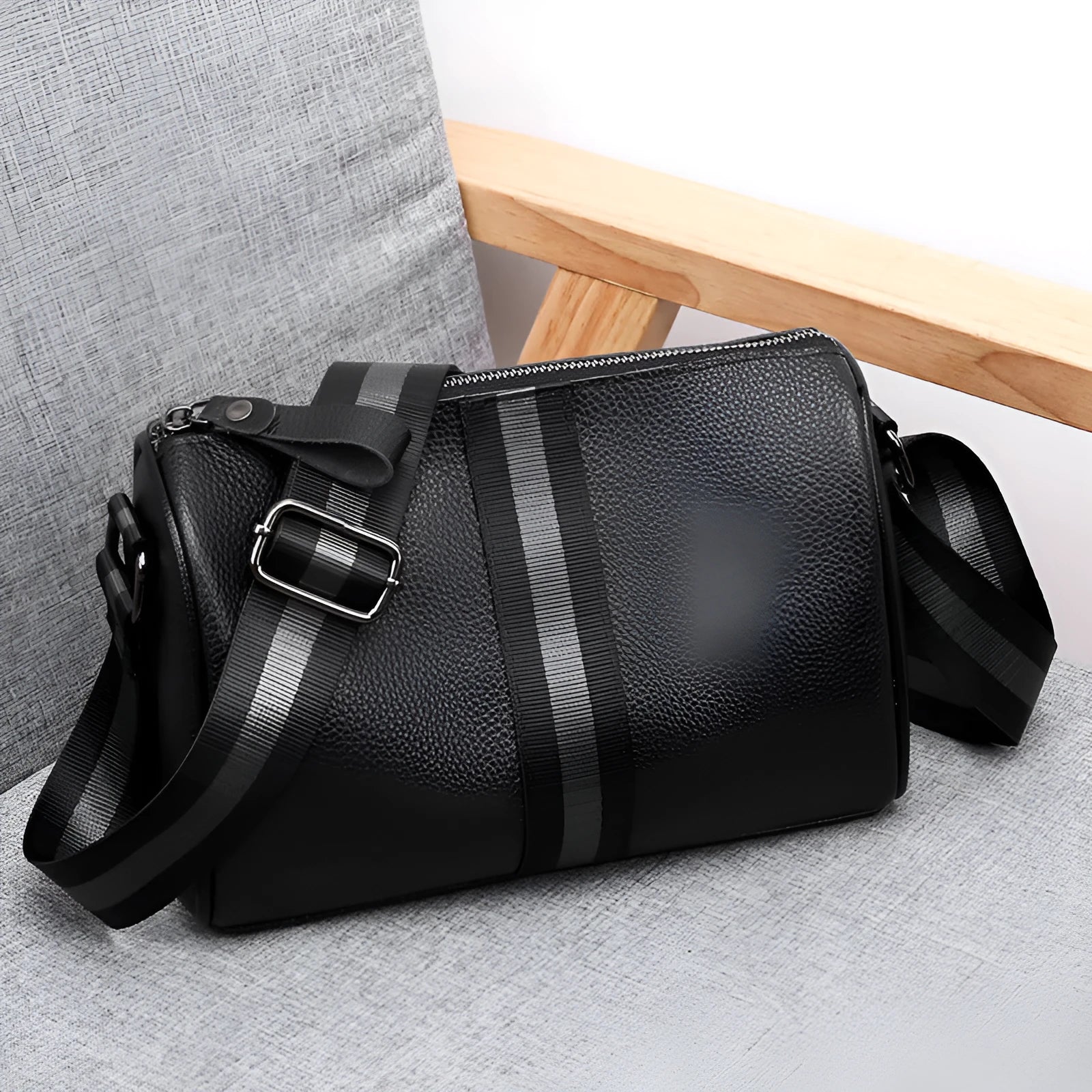 Black genuine leather crossbody bag showing adjustable strap and main compartment