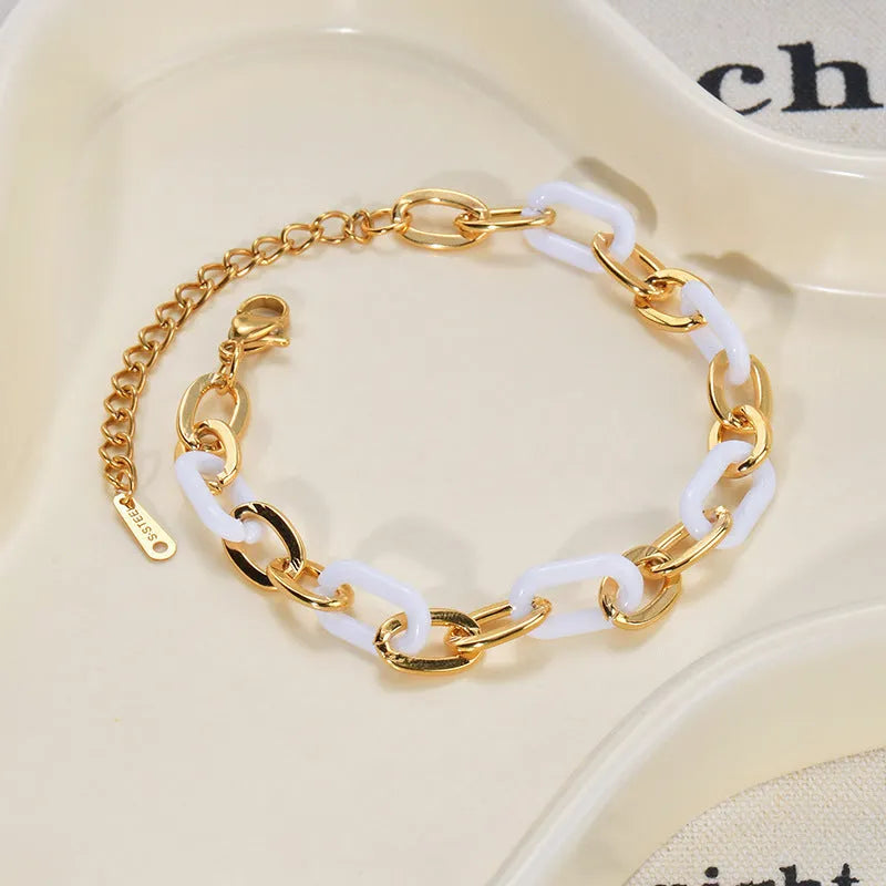 Stainless steel bracelet for women with a double-layered red resin heart charm on a metallic chain.