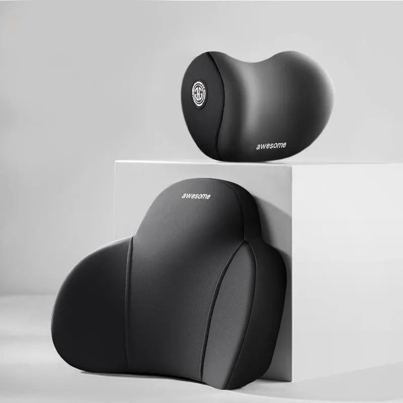Black and grey memory foam car headrest pillow and lumbar support pillow on a car seat.
