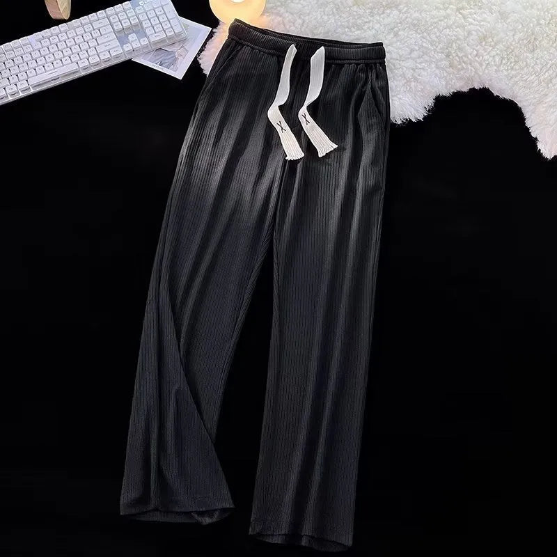 Men's loose straight-leg casual cotton trousers in black, shown flat.