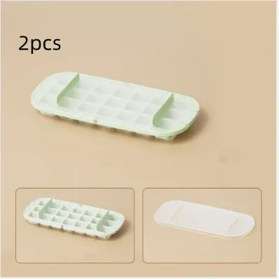 Yellow lever-action ice cube tray with high-capacity grid and attached ice shovel on a blue background.