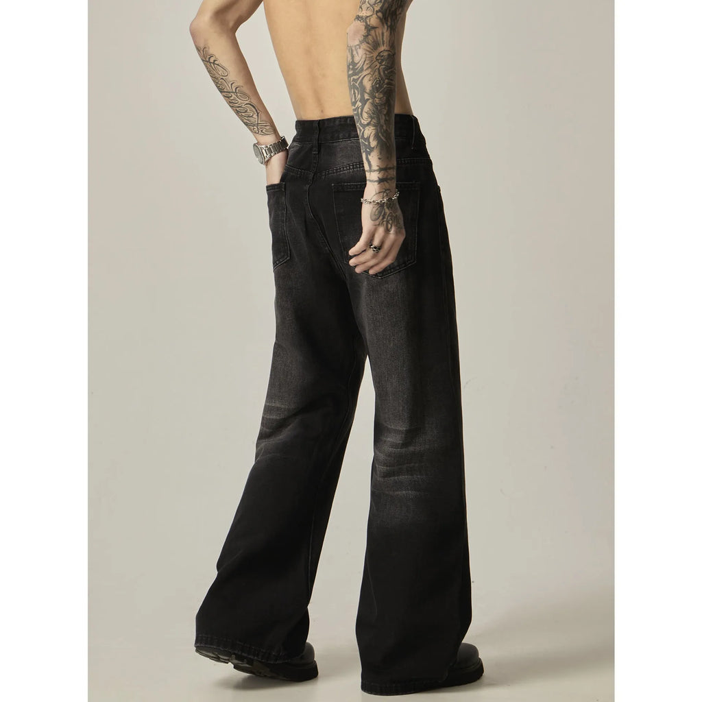 Black loose straight retro jeans with zipper fly closure on plain background