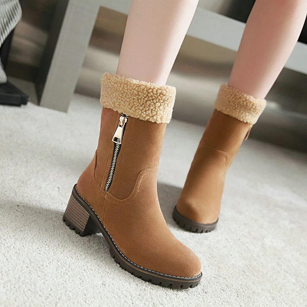 A pair of snow boots in black, grey, green, or orange with a rubber sole and plush lining.
