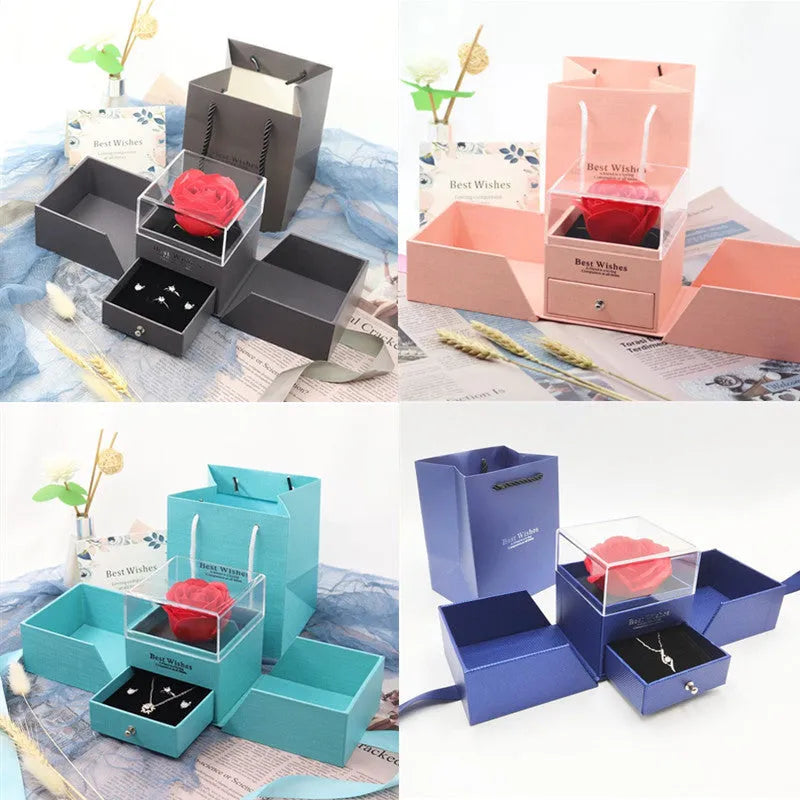 Blue jewellery gift box open showing a plastic eternal rose, with spaces for earrings and a necklace.