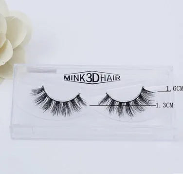 Pair of faux mink eyelashes with long tail and cotton stem against white background