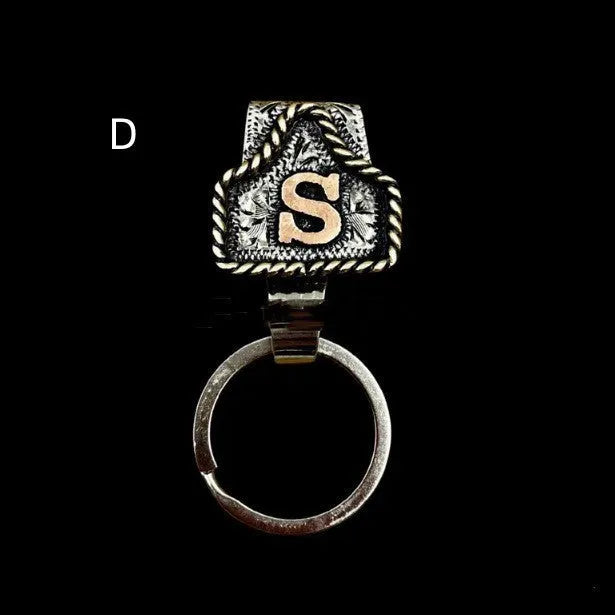 Handmade metal cow tag style key holder shown in one of its 26 colour options, attached to a keyring.