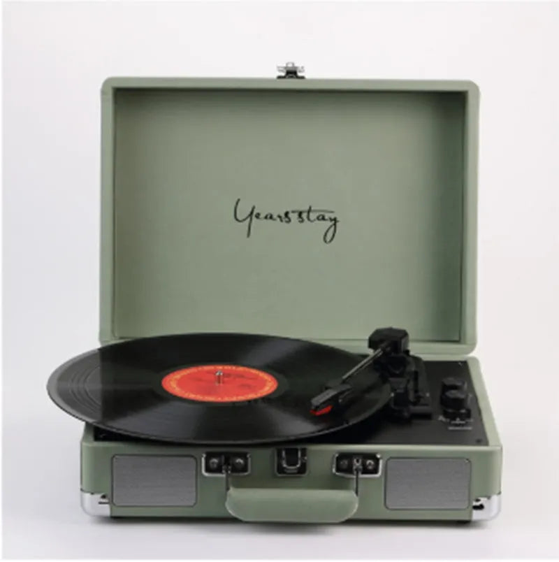 Leather-cased portable Bluetooth turntable for vinyl and film records in multiple colours.