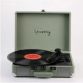 Leather-cased portable Bluetooth turntable for vinyl and film records in multiple colours.