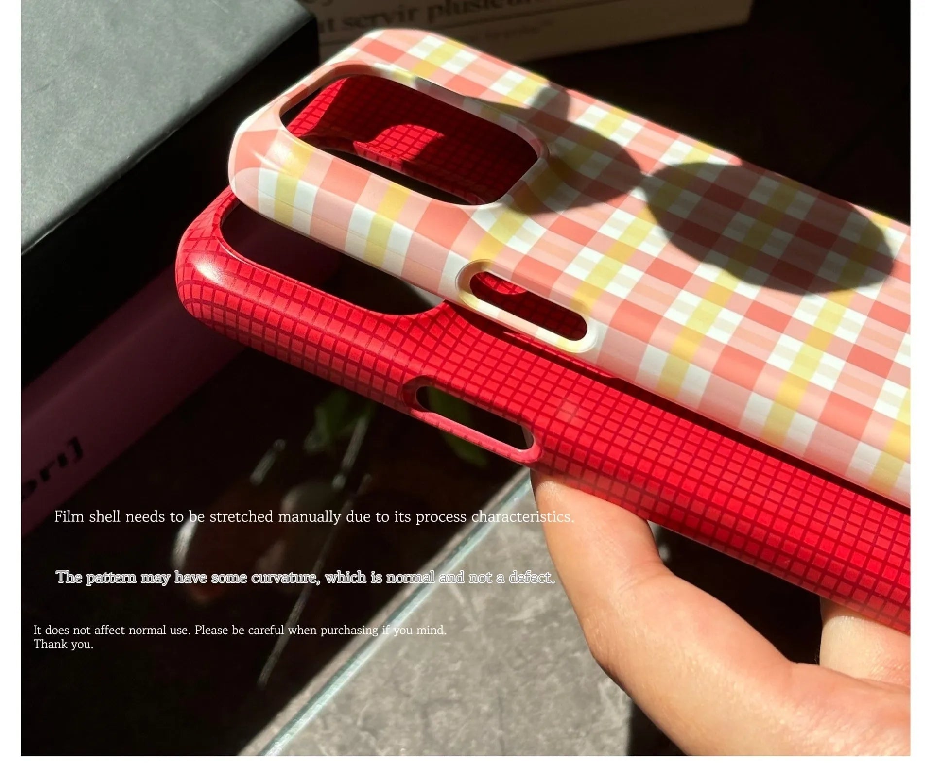 iPhone 15 Pro Max phone case with red and orange plaid design on glossy and frosted feilin shells.