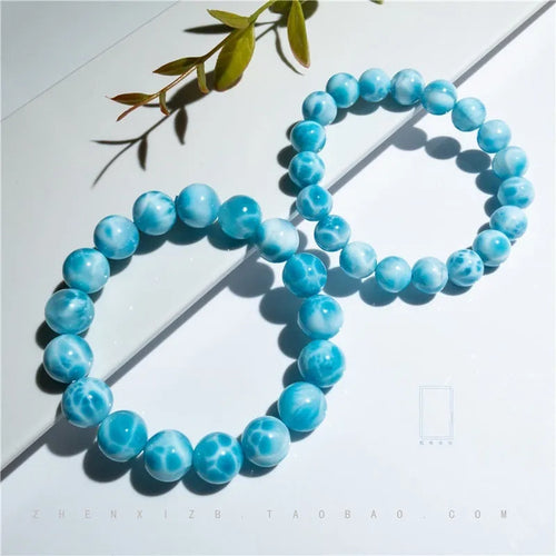 Blue Bodhi bracelet with natural sea-pattern crystal stones and pearl details in Maillard style.