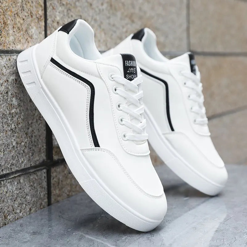 Men's low-top Korean style board sneakers in black with round toe, flat heel, and sewing line detail on the upper.