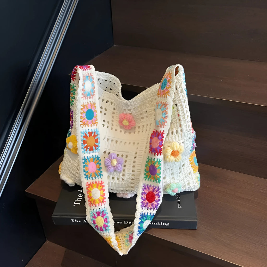 Woven beach shoulder bag with hollow weave pattern showing adjustable strap and interior