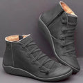 Women's black casual ankle booties with wedge heel and round toe on a rubber sole.